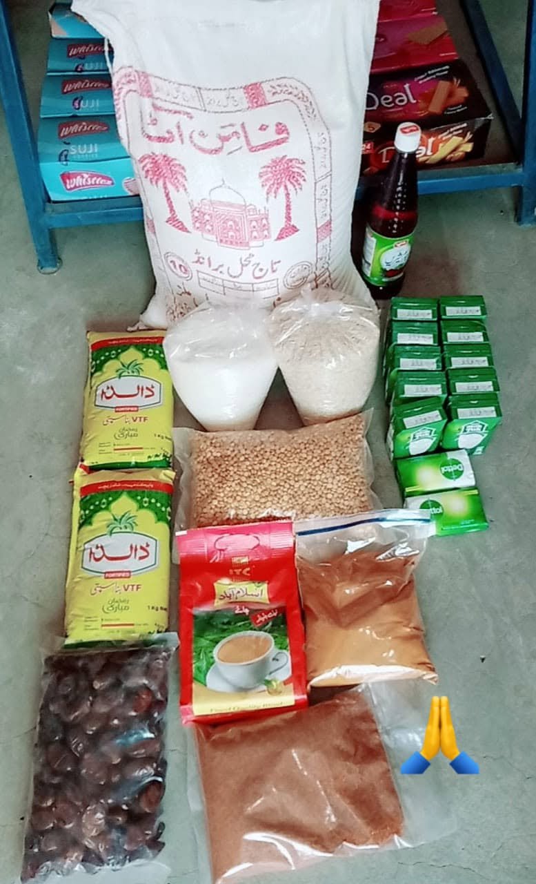 Contents of a Noori Welfare Foundation food parcel: flour, rice, cooking oil, lentils, sugar, tea, dates and soap